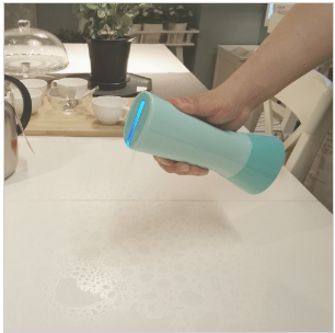 Tersano i-clean mini product being sprayed on table